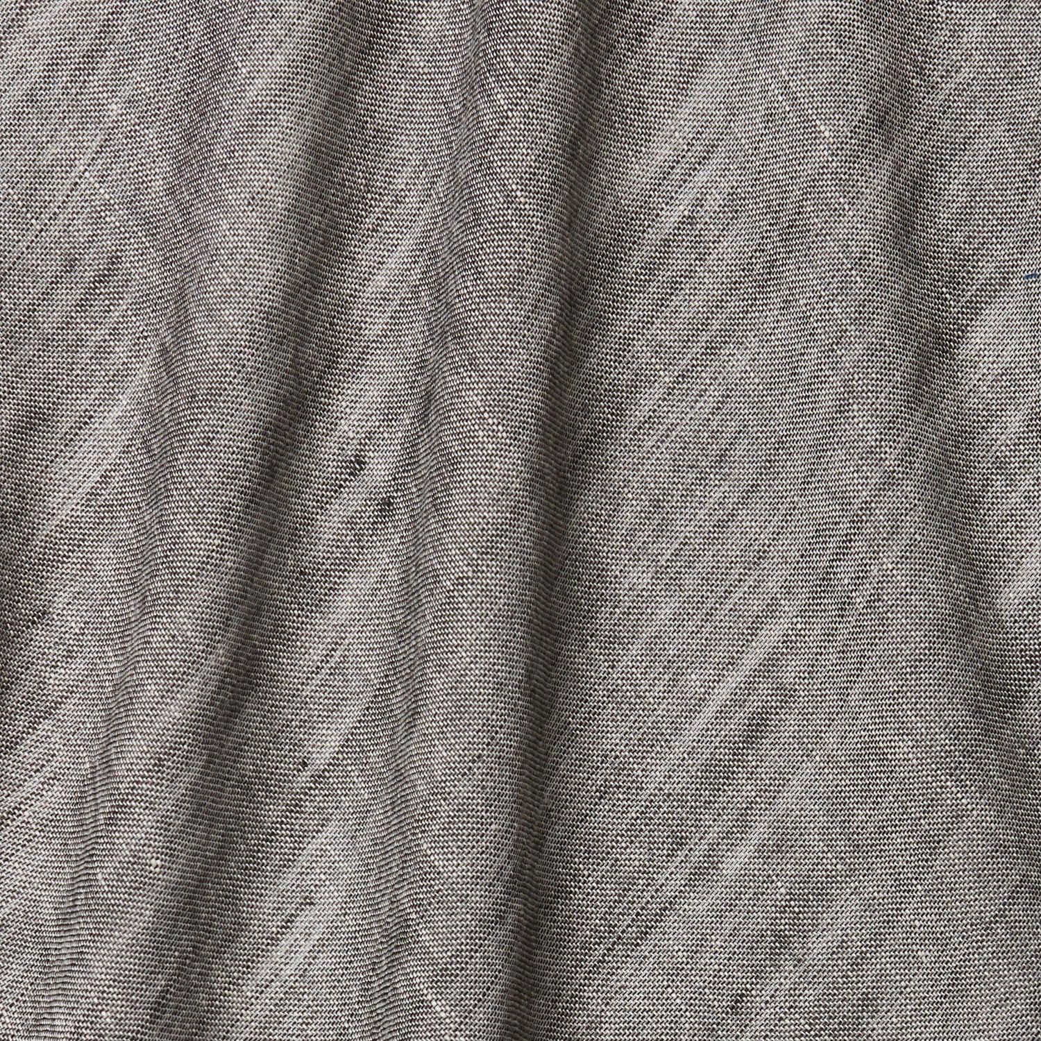 A draped swatch of open-weave sheer interior fabric in a mottled gray color.