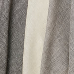 A row of three draped sheer interior fabric swatches in mottled gray and cream.