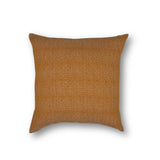 Handwoven pillow in a burnt orange color with a delicate diamond design. 