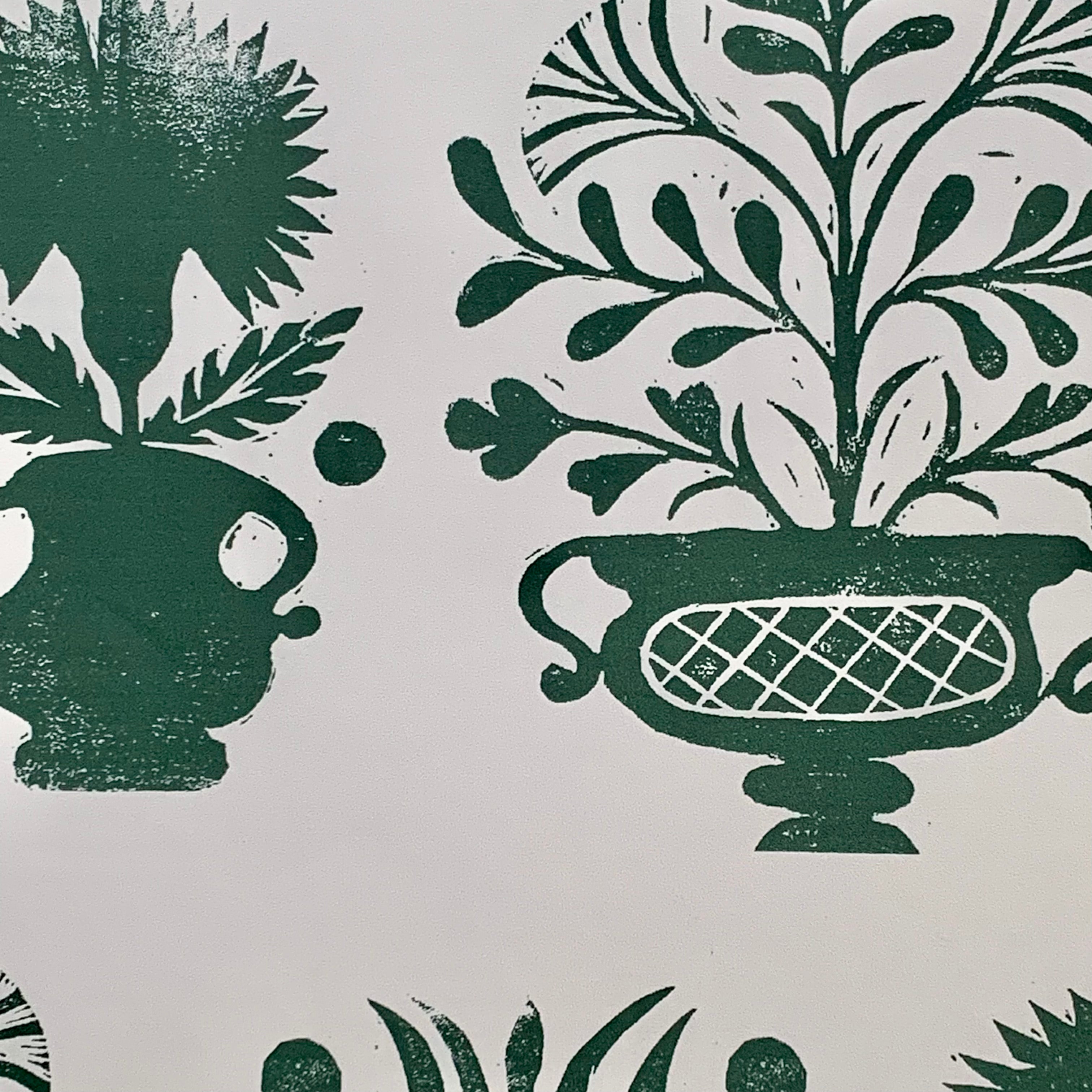 Close-up of wallpaper in a repeating vase and plant print in green on a white field.