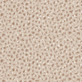 Detail of fabric in a painterly animal print in cream and brown on a tan field.