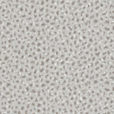 Detail of wallpaper in a painterly animal print in white and gray on a light gray field.