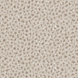 Detail of wallpaper in a painterly animal print in white and brown on a sable field.