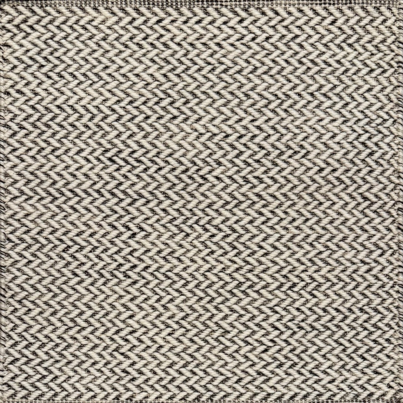 Textured rug with a herringbone pattern in white and charcoal grey