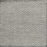 Textured rug with a herringbone pattern in white and slate blue. 