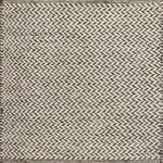 Textured rug with a herringbone pattern in white and brown.
