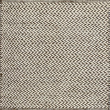 Textured rug with a herringbone pattern in white and brown.