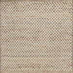 Textured rug with a herringbone pattern in white and tan.