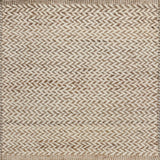 Textured rug with a herringbone pattern in white and tan.