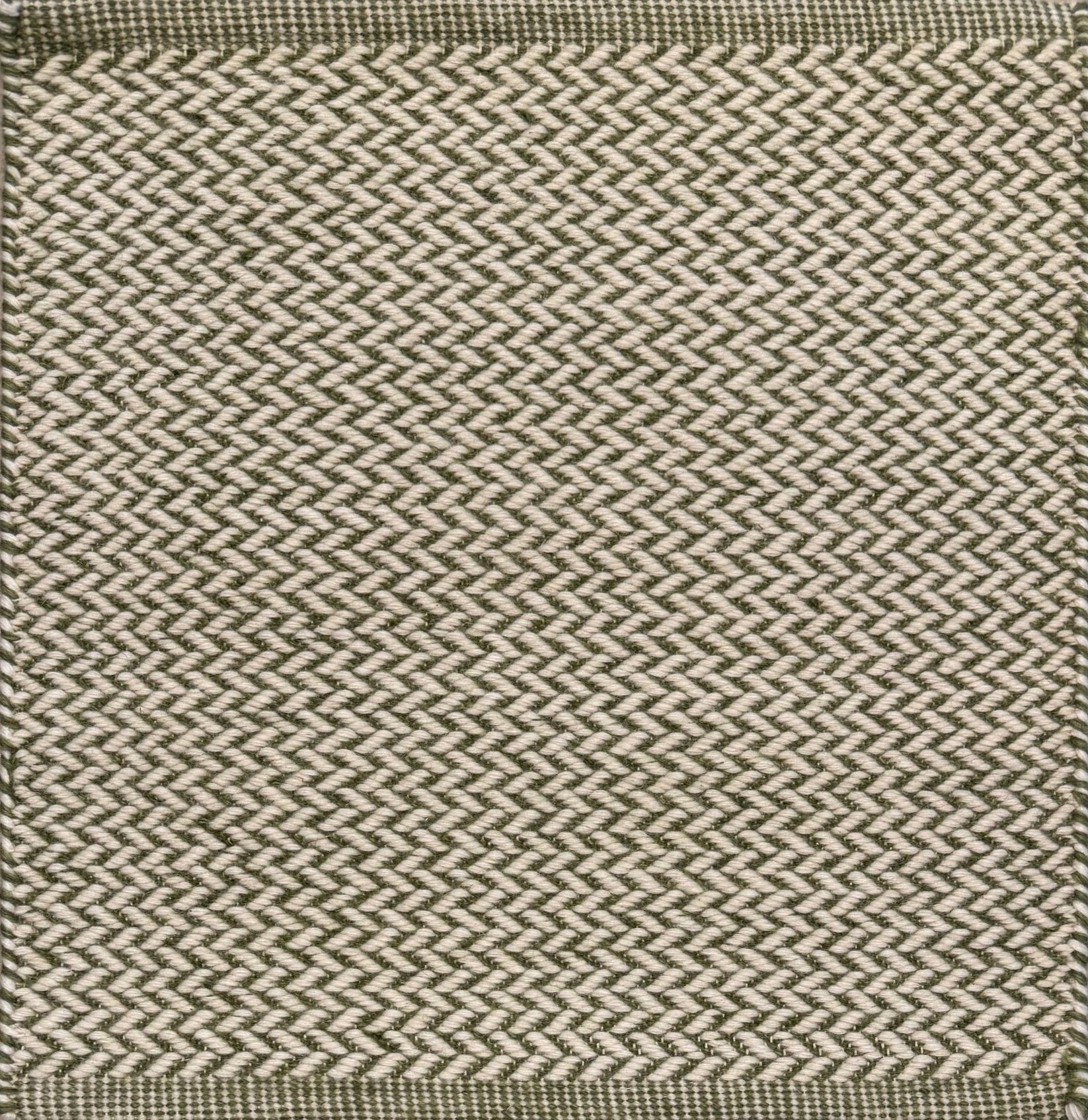 Textured rug with a herringbone pattern in white and green