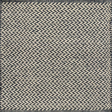 Textured rug with a herringbone pattern in white and navy blue