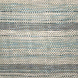 Handwoven rug detail in a stripe design in blue and grey 