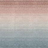 Broadloom carpet in a herringbone pattern in a subtle ombré color from teal blue to terracotta red.