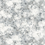 Detail of fabric in a painterly leaf print in shades of gray with a mottled white overlay.