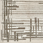 Detail of a contemporary rug with an ivory ground and a mix of thin lines and long slender rectangles in grey.