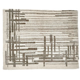 A contemporary rug with an ivory ground and a mix of thin lines and long slender rectangles in grey.