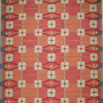 Decorative rug with geometric pattern on a red background