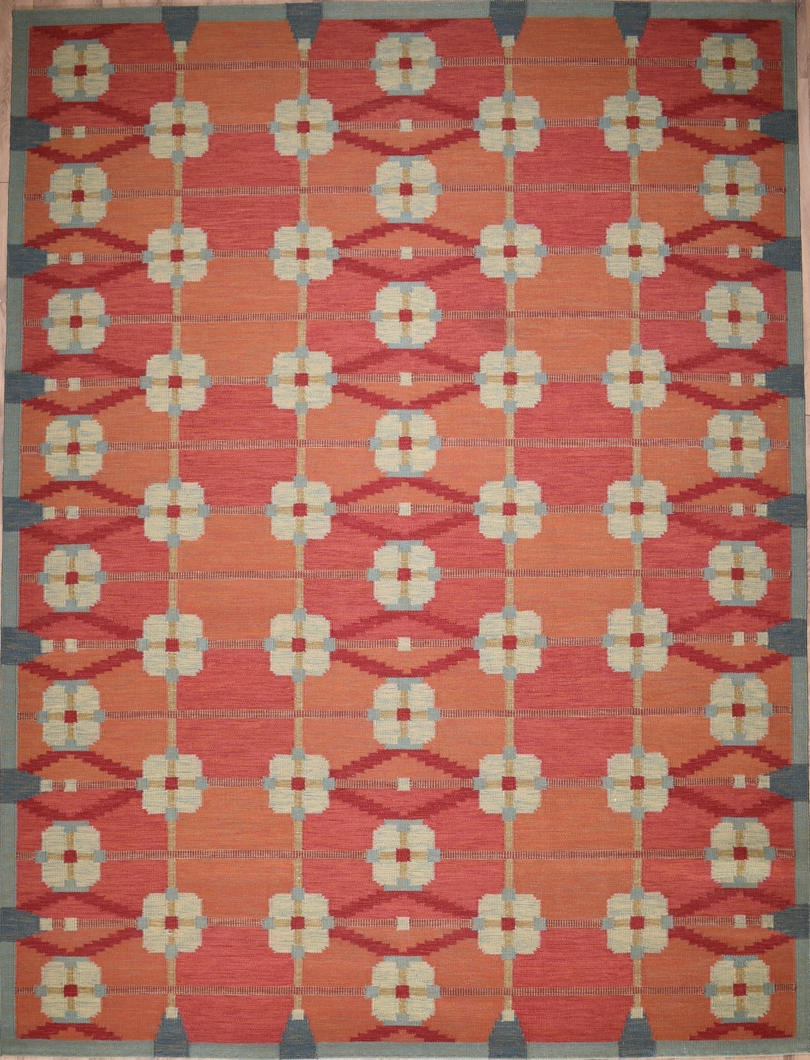 Decorative rug with geometric pattern on a red background