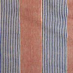 Detail of fabric in an irregular stripe print in red and navy on a white field.