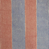 Detail of fabric in an irregular stripe print in red and navy on a white field.