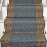 Striped flatweave runner in blue and tan on white staircase