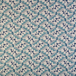 Detail of fabric in painterly diamond print in blue and navy on a white field.