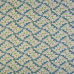 Detail of fabric in painterly diamond print in blue and green on a white field.