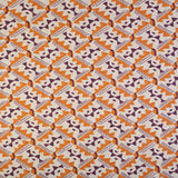 Detail of fabric in painterly diamond print in maroon and orange on a white field.