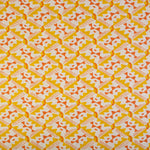 Detail of fabric in painterly diamond print in yellow and orange on a white field.