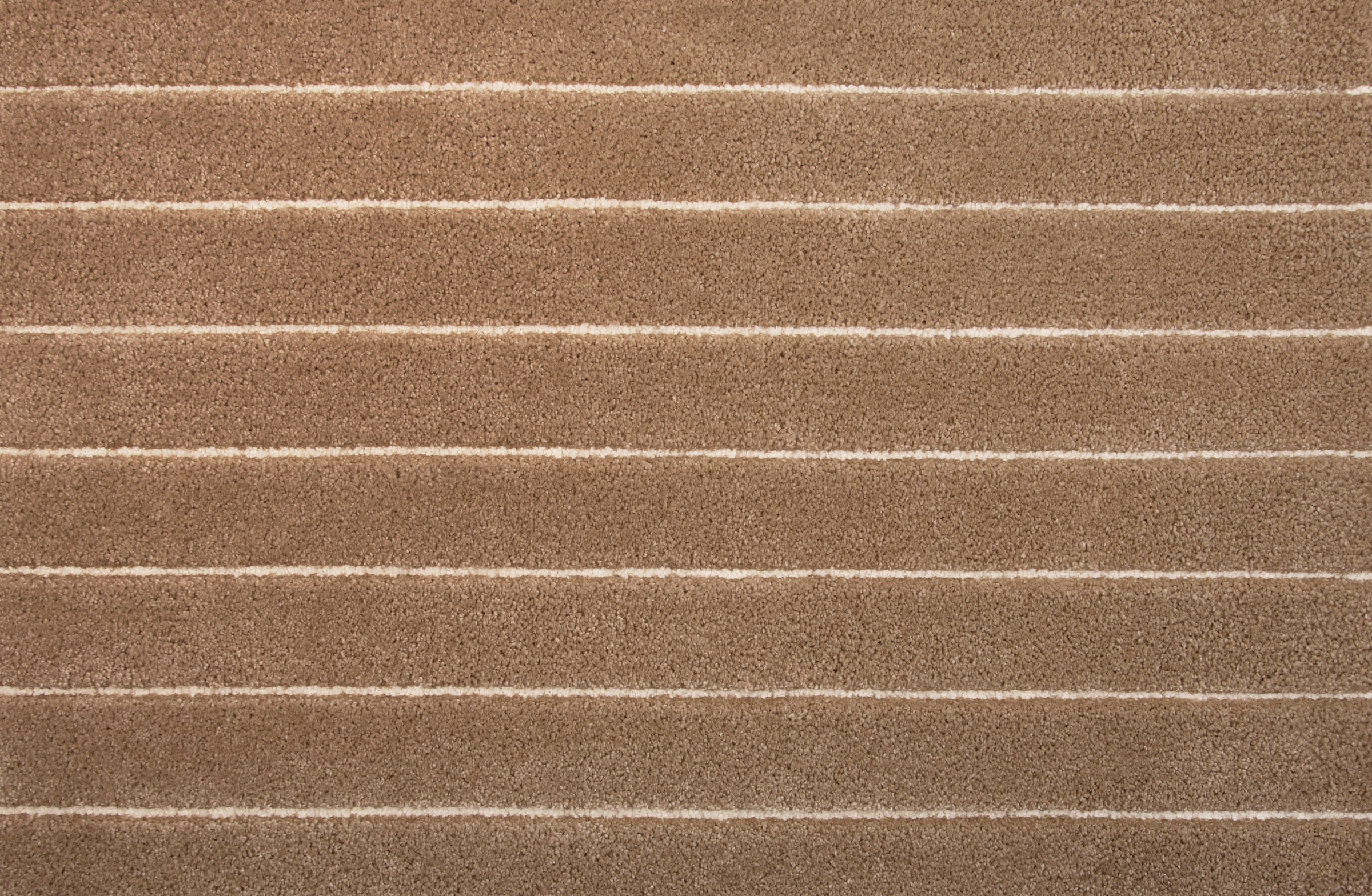 Broadloom carpet in a wide stripe pattern in camel and ivory. 