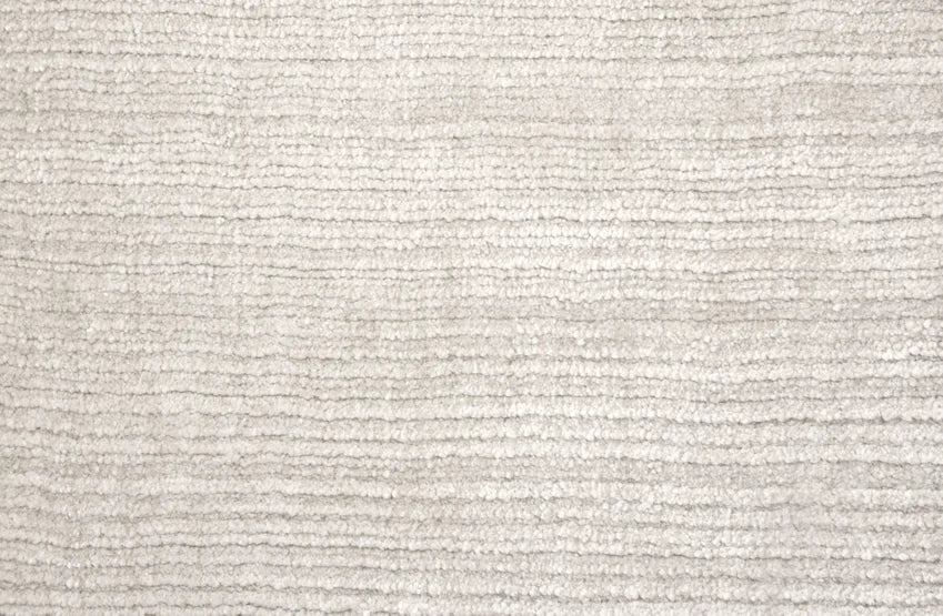 Broadloom carpet swatch in a solid pattern in a white light grey design