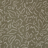 Detail of fabric in a minimalist floral print in cream on an olive field.