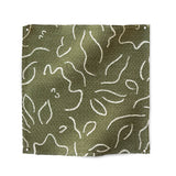 Square fabric swatch in a minimalist floral print in cream on an olive field.