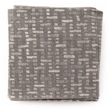 A stack of fabric swatches in a small-scale grid pattern in shades of gray.