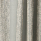 Draped printed fabric in a scrolling floral stripe pattern in cream on a light blue-gray field.