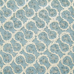 Detail of fabric in a meandering floral grid print in cream and navy on a light blue field.