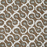 Detail of fabric in a meandering floral grid print in white and dark green on a brown field.