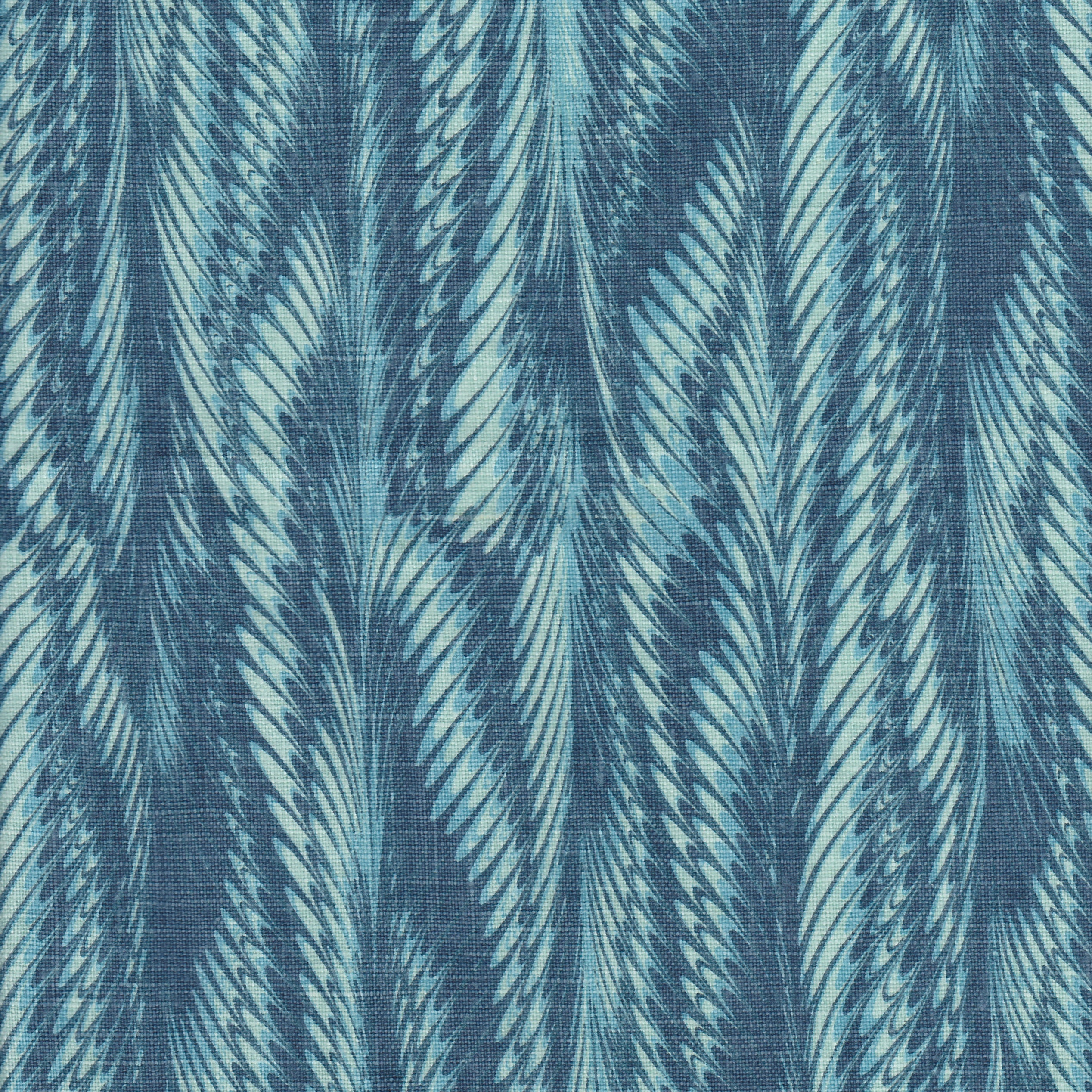 Detail of fabric in a marbled paint print in shades of blue and turquoise.