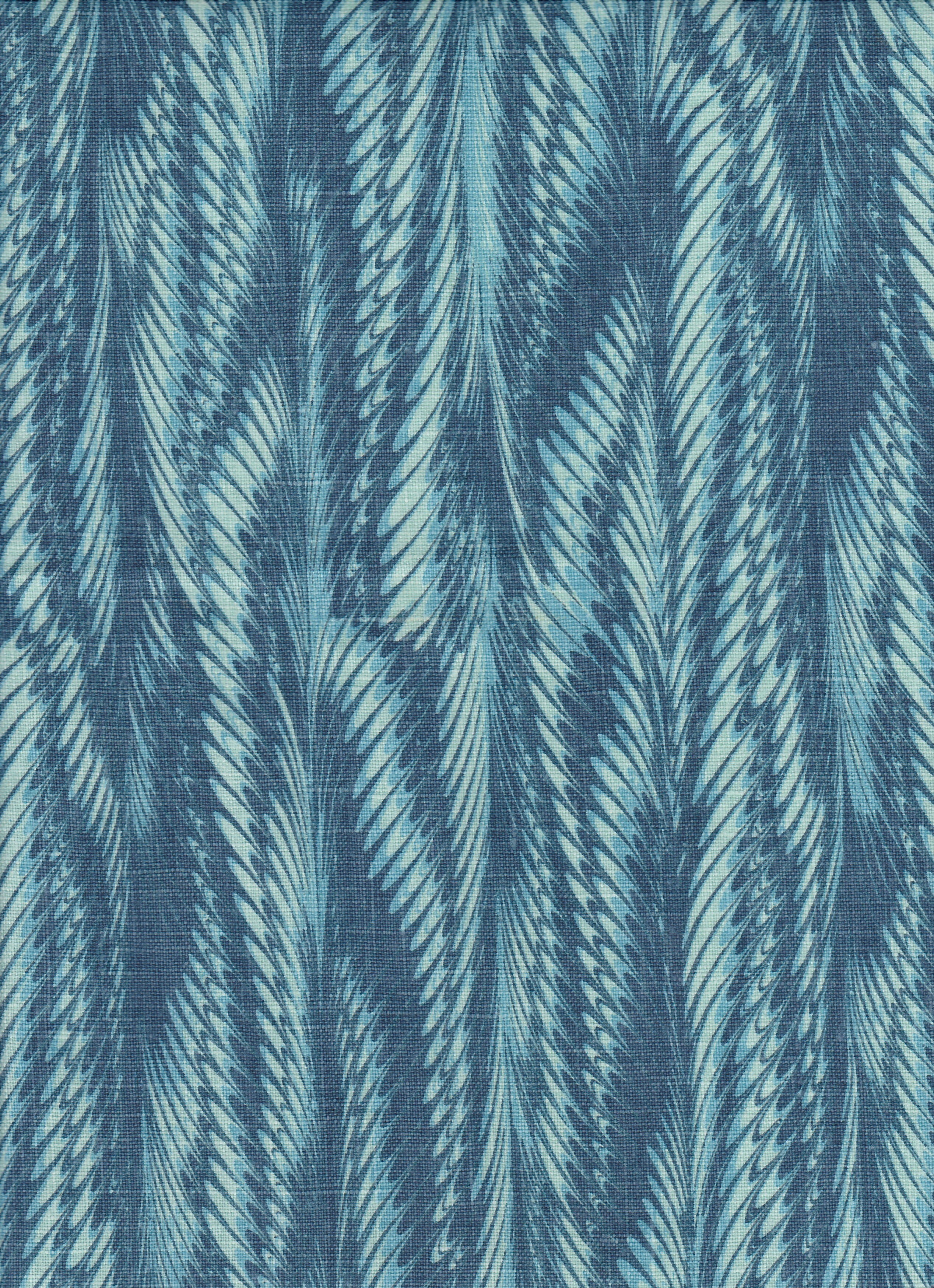 Detail of fabric in a marbled paint print in shades of blue and turquoise.