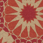 Detail of fabric in a geometric Moroccan print in shades of red, orange and tan.