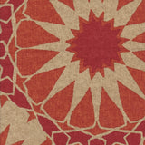 Detail of fabric in a geometric Moroccan print in shades of red, orange and tan.