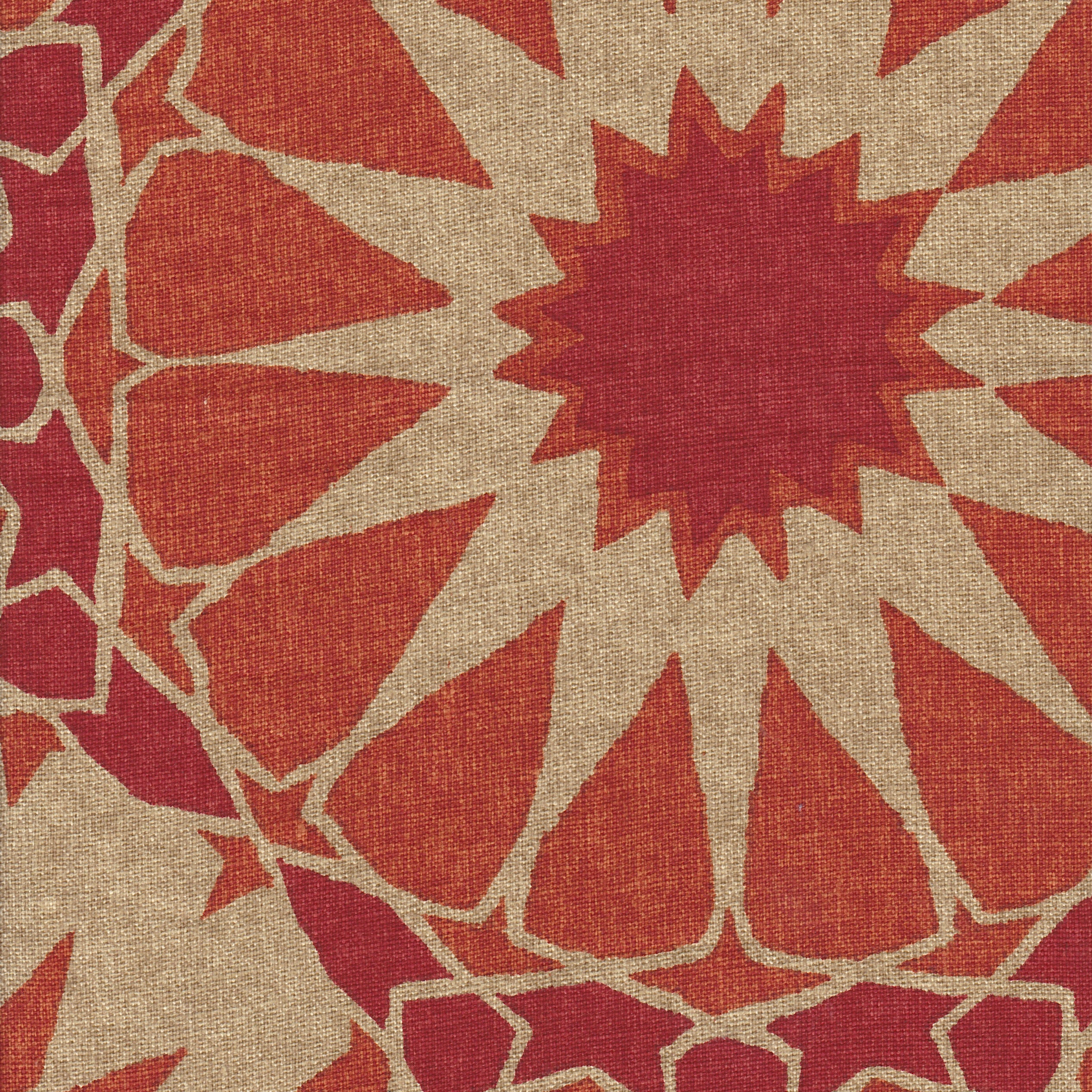 Detail of fabric in a geometric Moroccan print in shades of red, orange and tan.