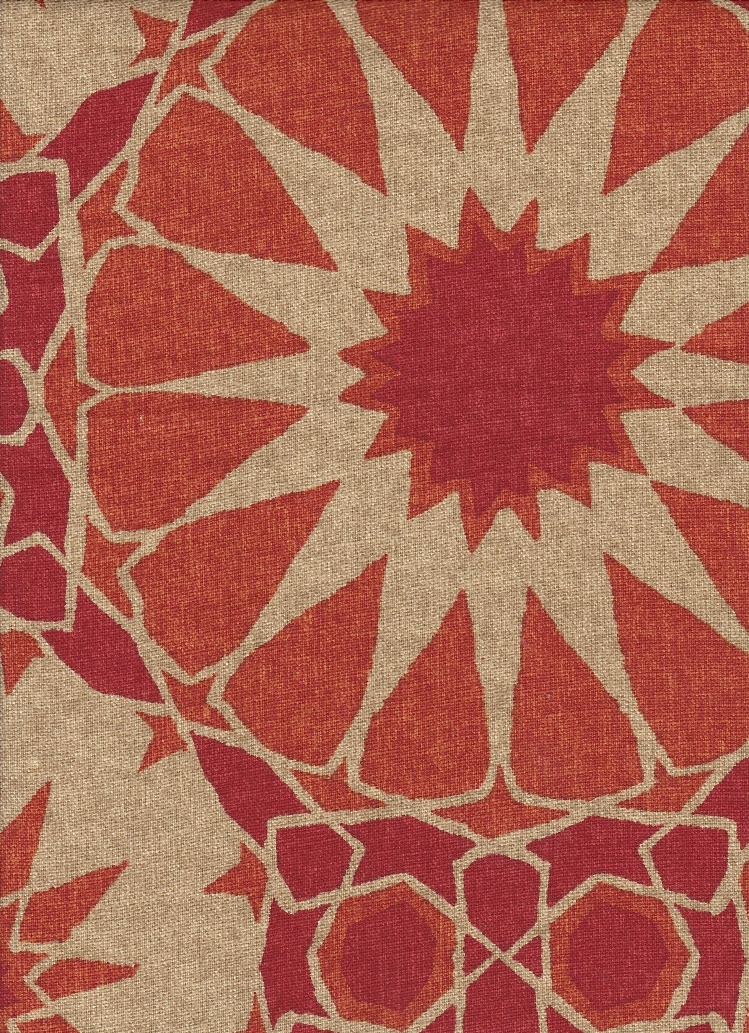 Detail of fabric in a geometric Moroccan print in shades of red, orange and tan.