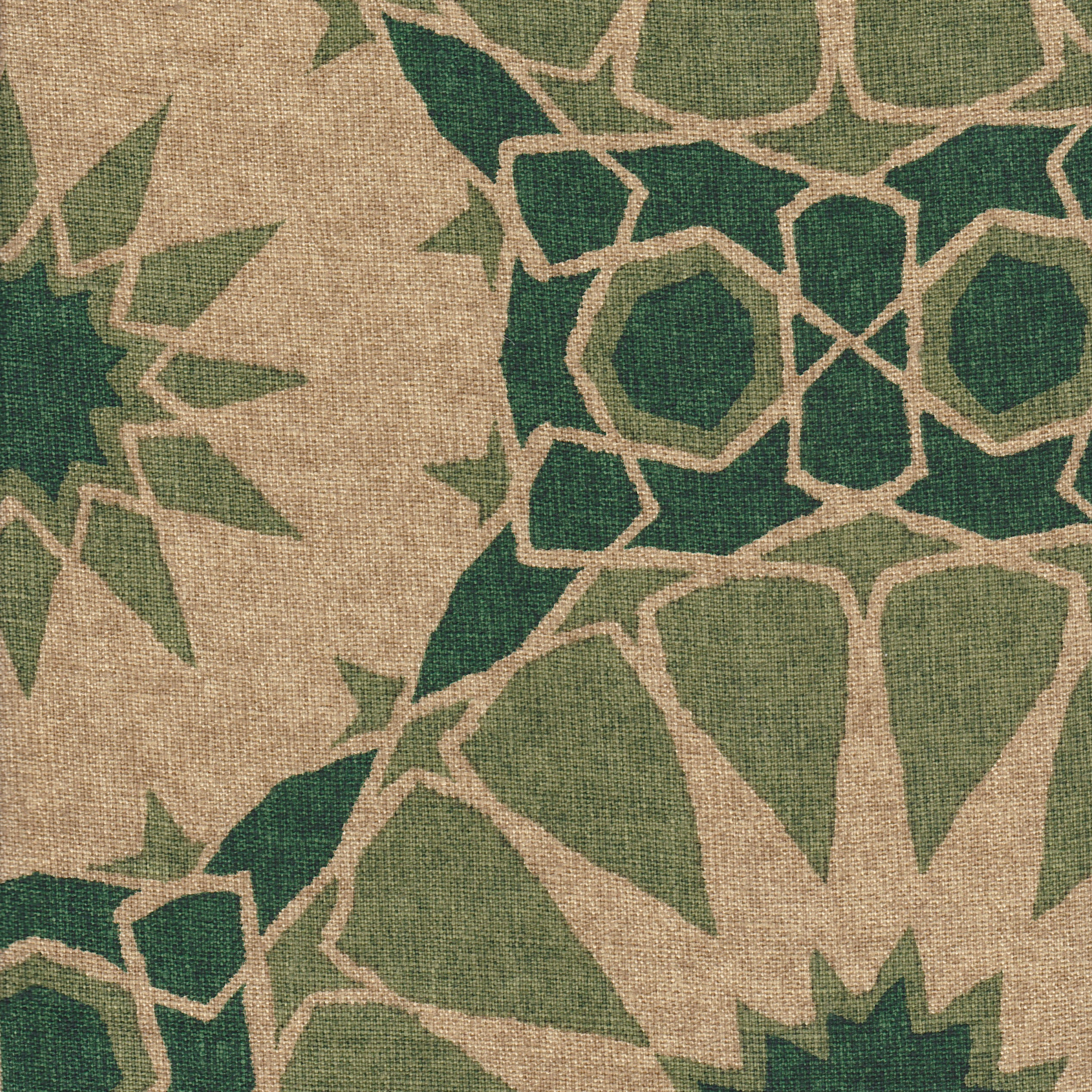 Detail of fabric in a geometric Moroccan print in shades of green and tan.