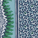 Detail of fabric in a bordered paisley print in shades of navy, green and white.