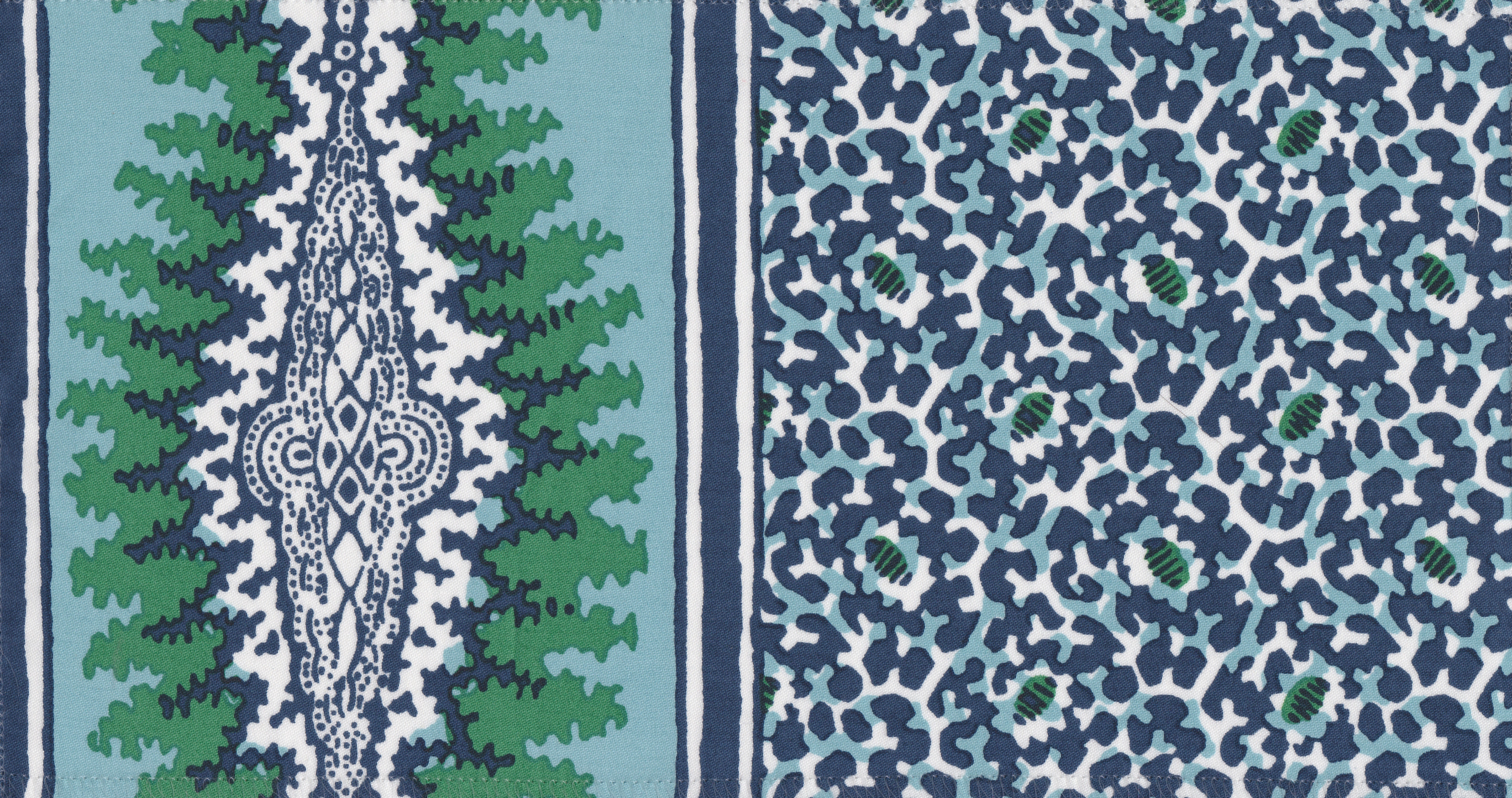 Detail of fabric in a bordered paisley print in shades of navy, green and white.