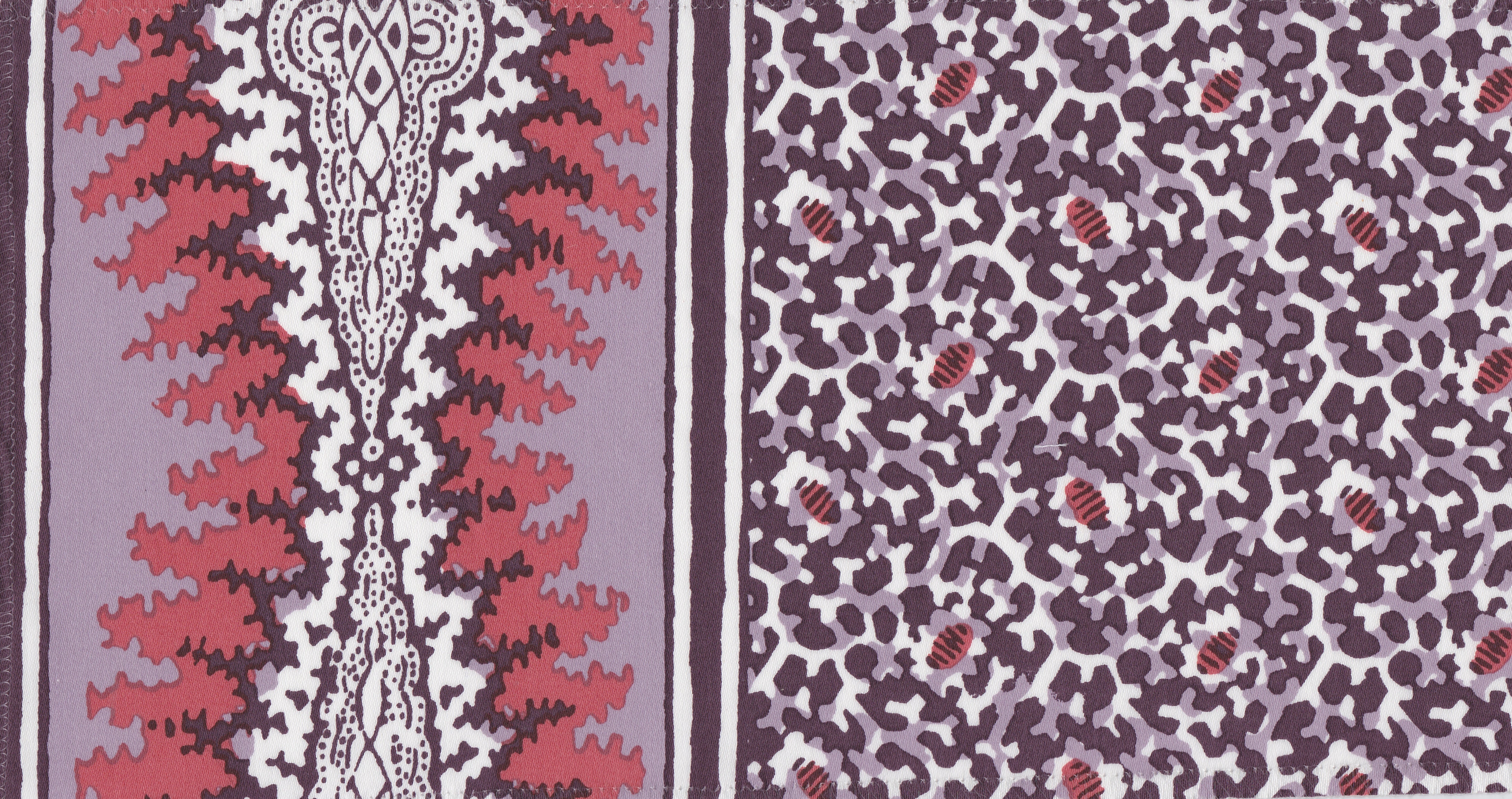 Detail of fabric in a bordered paisley print in shades of red, purple and white.