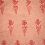 Detail of fabric in a floral grid print in red on a light orange field.