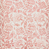 Detail of fabric in a dense botanical print in red and blush on a cream field.