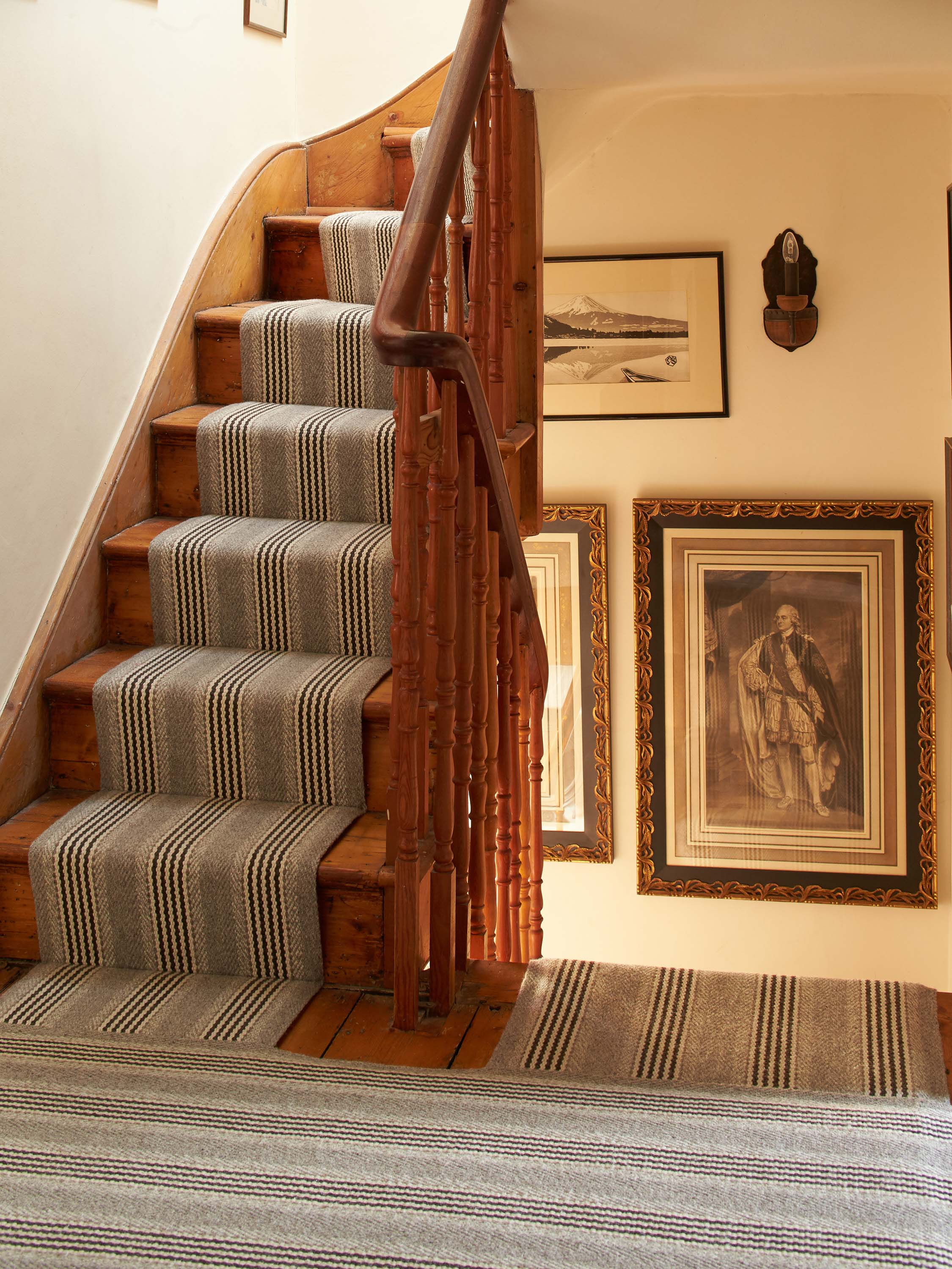 Striped flatweave runner in grey and black on wood staircase